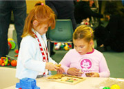 Picture of 2 children completing a puzzle together.